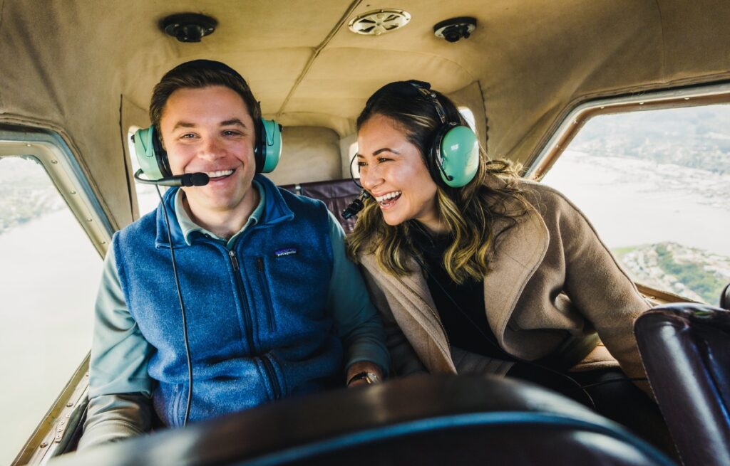 a happy laughing couple in a seaplane on a Norcal Seaplane Tour