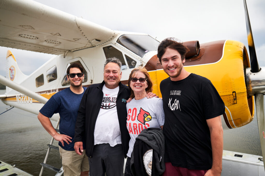 group smiling infront of seaplane