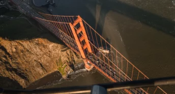 a view from a helicopter while on a golden gate bridge tour looking down out the window over the golden gate bridge